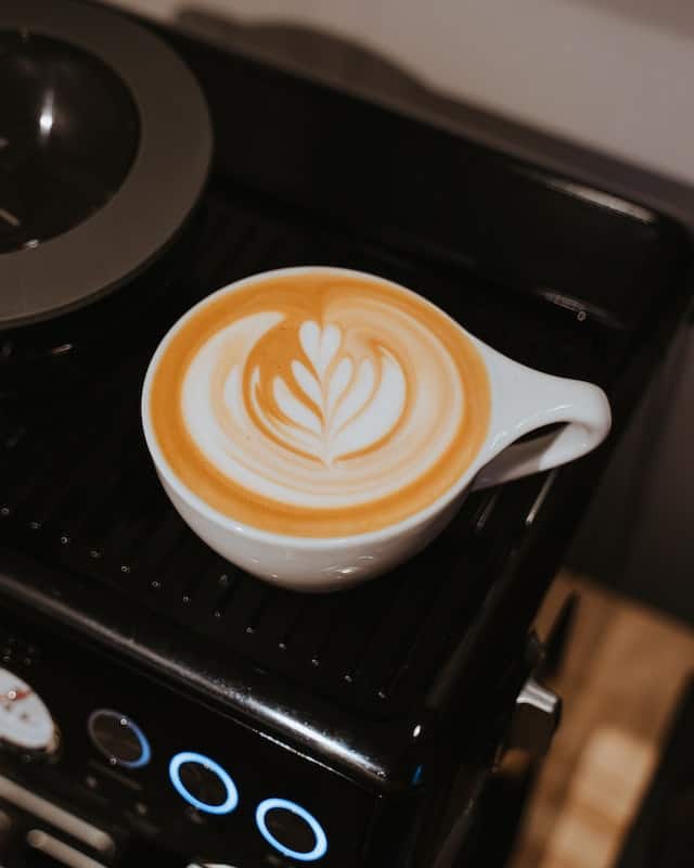 latte machine warming a cup