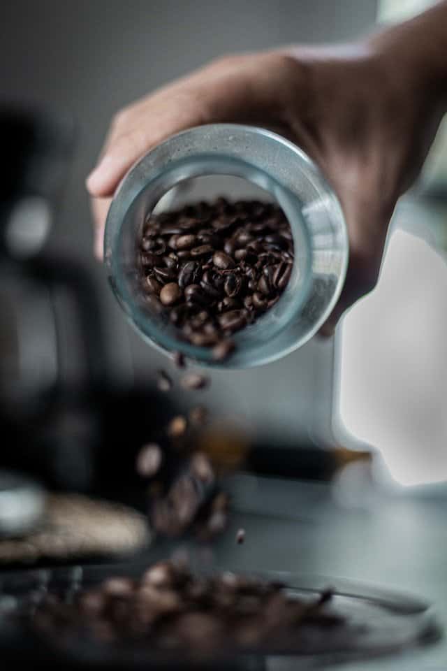 pouring coffee beans for electric grinder